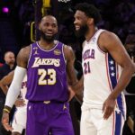 LOS ANGELES, CA - FEBRUARY 5: Joel Embiid #21 of the Philadelphia 76ers and LeBron James #23 of the Los Angeles Lakers smiles before the game on February 5, 2026 at Crypto.Com Arena in Los Angeles, California. (Photo by Jim Poorten/NBAE via Getty Images)