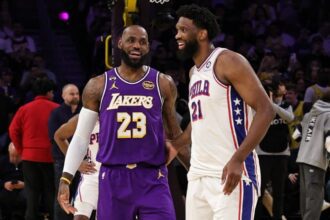 LOS ANGELES, CA - FEBRUARY 5: Joel Embiid #21 of the Philadelphia 76ers and LeBron James #23 of the Los Angeles Lakers smiles before the game on February 5, 2026 at Crypto.Com Arena in Los Angeles, California. (Photo by Jim Poorten/NBAE via Getty Images)