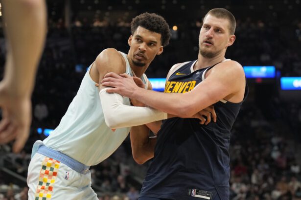 Jan 4, 2025; San Antonio, Texas, USA; San Antonio Spurs center Victor Wembanyama (1) and Denver Nuggets center Nikola Jokic (15) battle for position during an inbound pass in the second half at Frost Bank Center. Mandatory Credit: Scott Wachter-Imagn Images