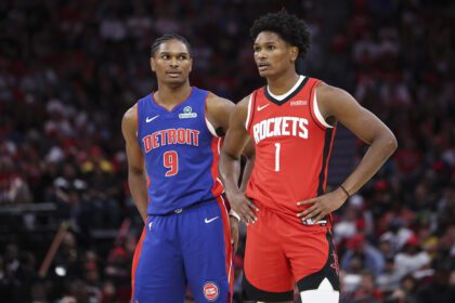 Oct 24, 2025; Houston, Texas, USA; Detroit Pistons guard Ausar Thompson (9) and twin brother Houston Rockets guard Amen Thompson (1) stand on the court during the third quarter at Toyota Center. Mandatory Credit: Troy Taormina-Imagn Images