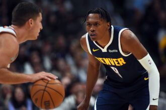Oct 25, 2025; Denver, Colorado, USA; Denver Nuggets guard Peyton Watson (8) defends against Phoenix Suns guard Collin Gillespie (12) during the first half at Ball Arena. Mandatory Credit: Christopher Hanewinckel-Imagn Images