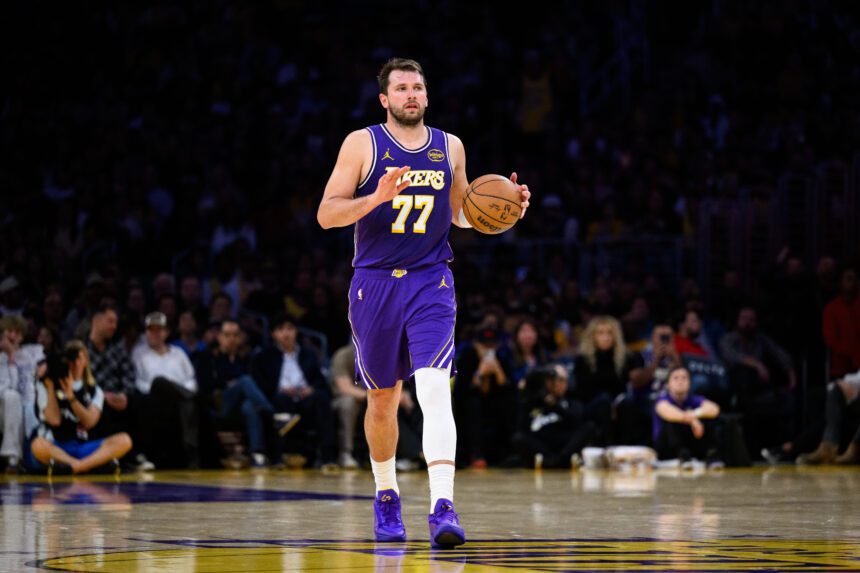 Mar 27, 2026; Los Angeles, California, USA; Los Angeles Lakers guard Luka Doncic (77) controls the ball during the second half against the Brooklyn Nets at Crypto.com Arena. Mandatory Credit: William Liang-Imagn Images