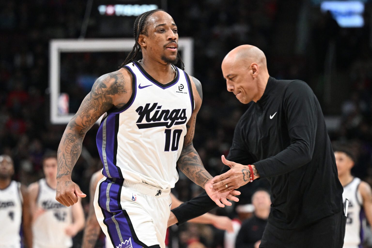 Apr 1, 2026; Toronto, Ontario, CAN; Sacramento Kings forward DeMar DeRozan (10) slaps hands with head coach Doug Christie after making a three-point basket against the Toronto Raptors in the second half at Scotiabank Arena. Mandatory Credit: Dan Hamilton-Imagn Images