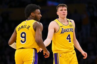 Mar 20, 2025; Los Angeles, California, USA; Los Angeles Lakers guard Dalton Knecht (4) fives guard Bronny James (9) after scoring against the Milwaukee Bucks during the second half at Crypto.com Arena. Mandatory Credit: Jonathan Hui-Imagn Images