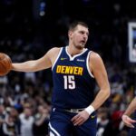 Dec 18, 2025; Denver, Colorado, USA; Denver Nuggets center Nikola Jokic (15) prepares to pass the ball in the first quarter against the Orlando Magic at Ball Arena. Mandatory Credit: Ron Chenoy-Imagn Images