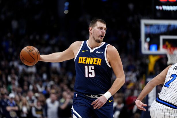 Dec 18, 2025; Denver, Colorado, USA; Denver Nuggets center Nikola Jokic (15) prepares to pass the ball in the first quarter against the Orlando Magic at Ball Arena. Mandatory Credit: Ron Chenoy-Imagn Images