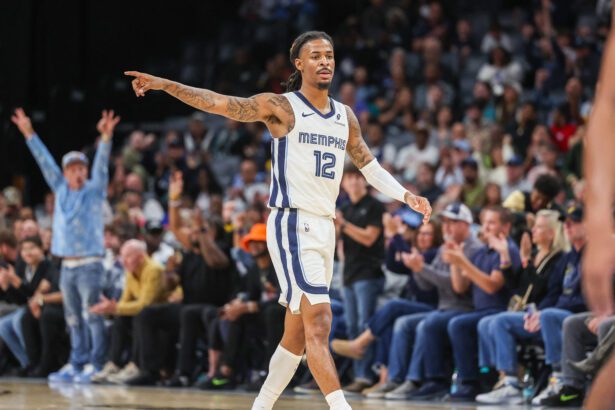 Oct 25, 2025; Memphis, Tennessee, USA; Memphis Grizzlies guard Ja Morant (12) reacts after a made basket against the Indiana Pacers during the first half at FedExForum. Mandatory Credit: Wesley Hale-Imagn Images