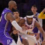 Feb 5, 2026; Los Angeles, California, USA; Los Angeles Lakers forward LeBron James (23) defends Philadelphia 76ers guard Vj Edgecombe (77) in the second half at Crypto.com Arena. Mandatory Credit: Jayne Kamin-Oncea-Imagn Images