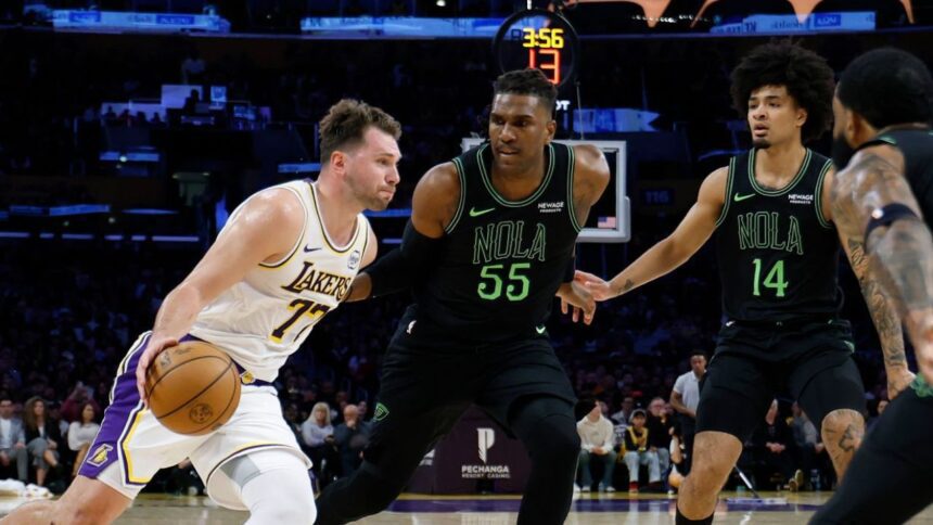 LOS ANGELES, CALIFORNIA - NOVEMBER 30: Luka Doncic #77 of the Los Angeles Lakers drives to the basket on Kevon Looney #55, Micah Peavy #14 and Saddiq Bey #41 of the New Orleans Pelicans during a 133-121 Lakers win at Crypto.com Arena on November 30, 2025 in Los Angeles, California. (Photo by Harry How/Getty Images)