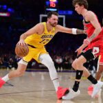 Mar 12, 2026; Los Angeles, California, USA; Los Angeles Lakers guard Luka Doncic (77) moves the ball against Chicago Bulls forward Matas Buzelis (14) during the first half at Crypto.com Arena. Mandatory Credit: Gary A. Vasquez-Imagn Images