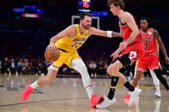 Mar 12, 2026; Los Angeles, California, USA; Los Angeles Lakers guard Luka Doncic (77) moves the ball against Chicago Bulls forward Matas Buzelis (14) during the first half at Crypto.com Arena. Mandatory Credit: Gary A. Vasquez-Imagn Images