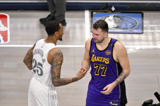 Dallas Mavericks forward P.J. Washington (25) and Los Angeles Lakers guard Luka Doncic (77) during the game between the Dallas Mavericks and the Los Angeles Lakers at American Airlines Center.