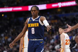 Jan 9, 2026; Denver, Colorado, USA; Denver Nuggets guard Peyton Watson (8) reacts during a timeout in the first quarter against the Atlanta Hawks at Ball Arena. Mandatory Credit: Ron Chenoy-Imagn Images