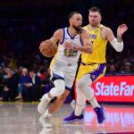 Apr 3, 2025; Los Angeles, California, USA; Golden State Warriors guard Stephen Curry (30) moves to the basket against Los Angeles Lakers guard Luka Doncic (77) during the second half at Crypto.com Arena. Mandatory Credit: Gary A. Vasquez-Imagn Images