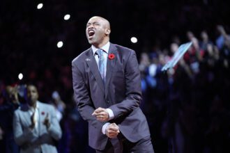 Former Toronto Raptors player Vince Carter reacts during his player number retirement ceremony at halftime of a game against the Sacramento Kings at Scotiabank Arena.