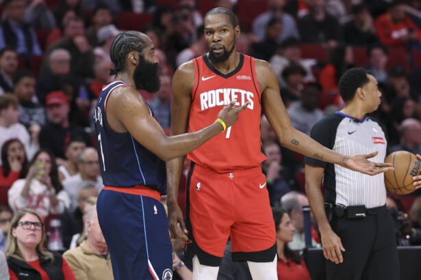 Houston, Texas, USA; Houston Rockets forward Kevin Durant (7) talks with Los Angeles Clippers guard James Harden (1) during the third quarter at Toyota Center. Mandatory Credit: Troy Taormina-Imagn Images