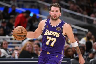Indianapolis, Indiana, USA; Los Angeles Lakers guard Luka Doncic (77) dribbles the ball down court during the second half against the Indiana Pacers at Gainbridge Fieldhouse. Mandatory Credit: Marc Lebryk-Imagn Images