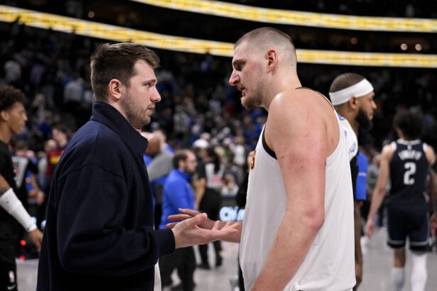 Dallas, Texas, USA; Dallas Mavericks guard Luka Doncic (left) talks with Denver Nuggets center Nikola Jokic (right) after the game at the American Airlines Center. Mandatory Credit: Jerome Miron-Imagn Images