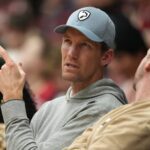 Stanford, California, USA; Golden State Warriors general manager Mike Dunleavy Jr. sits courtside during the first half of the game between the Stanford Cardinal and the CSUN Matadors at Maples Pavilion. Mandatory Credit: Darren Yamashita-Imagn Images