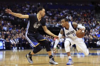 Dallas, TX, USA; Dallas Mavericks guard Monta Ellis (11) dribbles as Golden State Warriors guard Stephen Curry (30) defends during the game at American Airlines Center. Golden State won 123-110. Mandatory Credit: Kevin Jairaj-USA TODAY Sports