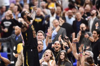 May 5, 2018; Cleveland, OH, USA; Cleveland Cavaliers forward LeBron James (23) stands on the scorer's table after hitting the final shot to win the game against the Toronto Raptors in game three of the second round of the 2018 NBA Playoffs at Quicken Loans Arena. Mandatory Credit: Ken Blaze-USA TODAY Sports