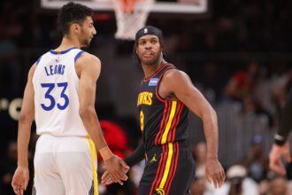 Mar 21, 2026; Atlanta, Georgia, USA; Atlanta Hawks guard Buddy Hield (8) talks to Golden State Warriors forward Malevy Leons (33) in the fourth quarter at State Farm Arena. Mandatory Credit: Brett Davis-Imagn Images