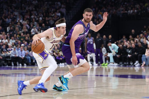 Oct 25, 2026; Salt Lake City, Utah, USA; Los Angeles Lakers guard Austin Reaves (15) drives against Utah Jazz guard Svi Mykhailiuk (10) during the first half at Delta Center. Mandatory Credit: Rob Gray-Imagn Images