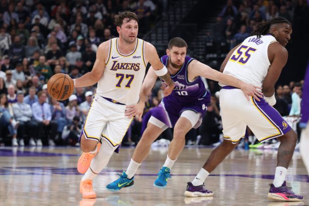 Oct 25, 2026; Salt Lake City, Utah, USA; Los Angeles Lakers guard Luka Doncic (77) uses a screen by forward Kevon Looney (55) against Utah Jazz guard Svi Mykhailiuk (10) during the first half at Delta Center. Mandatory Credit: Rob Gray-Imagn Images